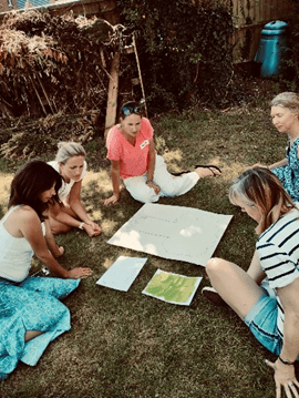 Picture of students sitting on the grass